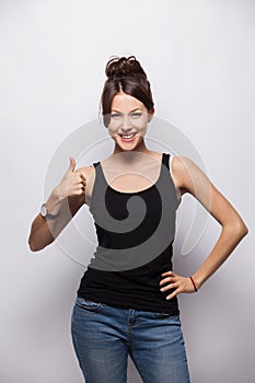 Happy smiling beautiful young brunette woman showing thumbs up gesture, isolated on white background.