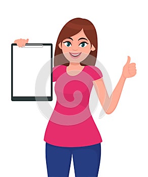 Happy smiling beautiful young woman holding / showing a blank clipboard and gesture hand thumbs up sign.