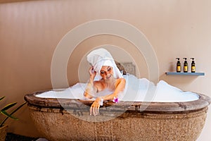 Happy smiling beautiful young woman in a luxurious spa hotel