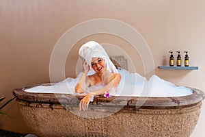 Happy smiling beautiful young woman in a luxurious spa hotel