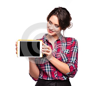 Happy smiling beautiful young woman showing blank tablet pc for copyspace