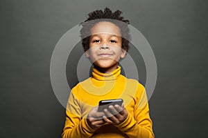 Happy smiling black child boy with smartphone