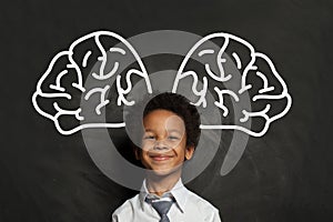 Happy smiling black child student boy with big brain, idea and brainstorming concept