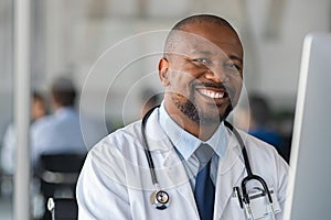 Happy smiling black doctor looking at camera