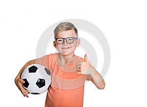 Happy smiling blond child boy in pink T-shirt with soccer ball showing thumb up isolated on white background. Winner kid