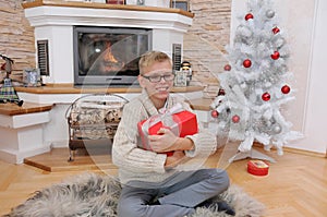 Happy smiling boy with Christmas gift