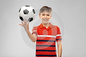 Happy smiling boy holding soccer ball