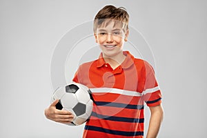 Happy smiling boy holding soccer ball