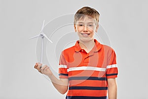 Happy smiling boy holding toy wind turbine