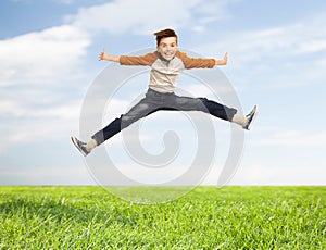 Happy smiling boy jumping in air
