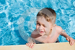 Happy smiling boy at pool