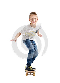 Happy smiling boy riding a skateboard