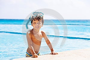 Happy smiling boy with snorkel mask on his head