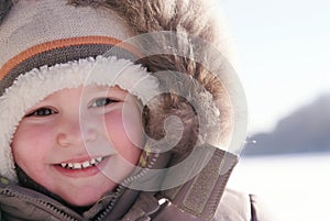 Happy smiling boy in winter clothes