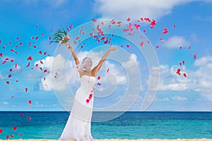 Happy smiling bride on the wedding day on tropical beach an