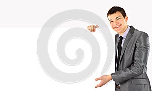 Happy smiling business man showing blank signboard