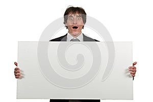 Happy smiling business man showing blank signboard, isolated over white background