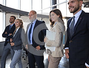 Happy smiling business team standing in a row at office