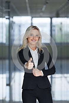 Happy smiling business woman with ok hand sign.