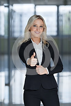 Happy smiling business woman with ok hand sign up