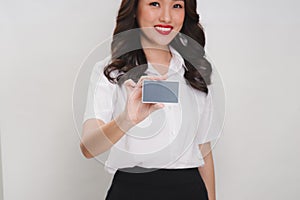 Happy smiling business woman showing credit card. Portrait of sm