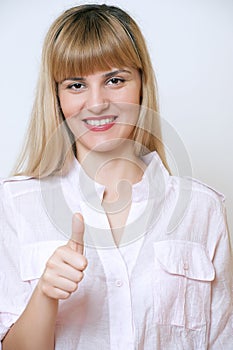 Happy smiling business woman showing thumbs up gesture.