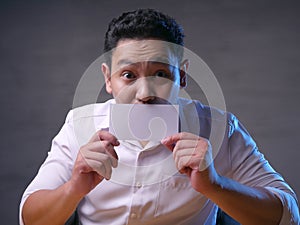 Happy Smiling Businessman Covering His Face With Blank Paper Card