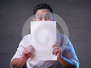 Happy Smiling Businessman Covering His Face With Blank Paper Card