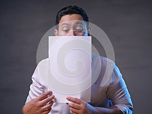 Happy Smiling Businessman Covering His Face With Blank Paper Card