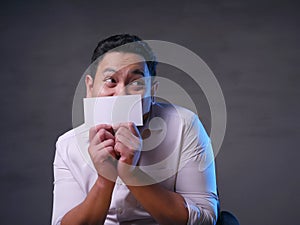 Happy Smiling Businessman Covering His Face With Blank Paper Card