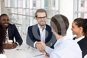 Happy smiling businessman handshake with business partner for successful agreement