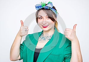 Happy smiling businesswoman wearing in green jacket with thumbs up gesture