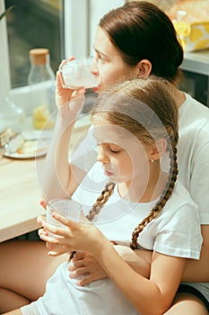 The happy smiling caucasian family in the kitchen preparing breakfast