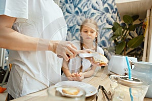 The happy smiling caucasian family in the kitchen preparing breakfast