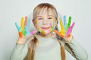 Happy smiling child girl art school student showing her colorful painted hands on white. Girl drawing