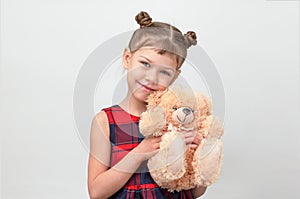 Happy and smiling child hugging teddy bear on white background