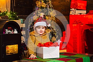 Happy smiling child with new year gift. Merry Christmas and Happy Holiday. Girl kid santa hat with present counting time