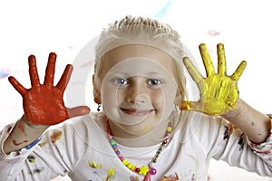 Happy smiling child with painted hands