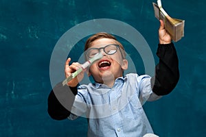 Happy smiling child wearing eyeglasses with cash