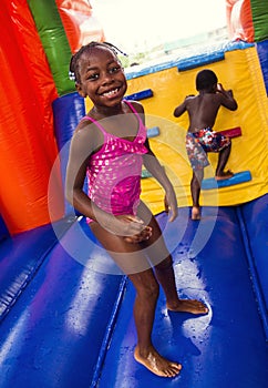 Happy smiling children playing on an inflatable bounce house
