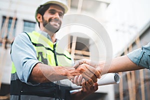 Construction workers shaking hands