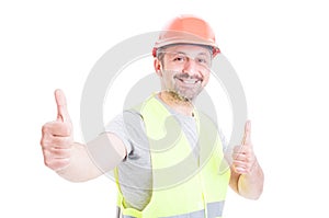 Happy smiling constructor or builder showing double like sign