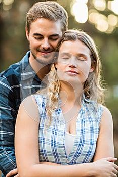 Happy smiling couple embracing with eyes closed