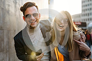 Happy smiling couple having fun together in city. People travel business happiness concept