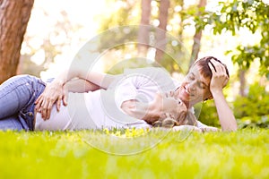 Happy Smiling Couple Relaxing on Green Grass