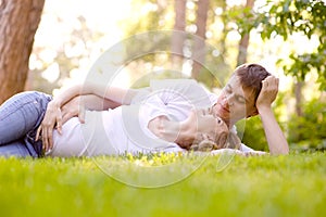 Happy Smiling Couple Relaxing on Green Grass