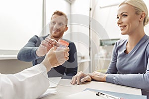 Happy smiling couple visiting doctor