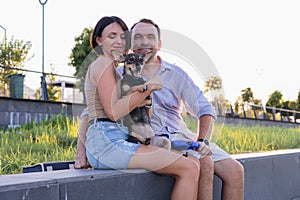 A happy smiling couple walking, hugging and kissing in park on late summer sunset photo