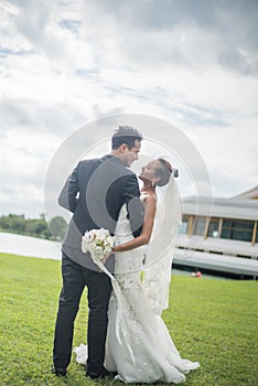 Happy smiling couple in wedding. Pretty Bride and handsome groom gorgeous posting