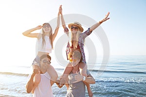 Happy smiling couples playing at the beach